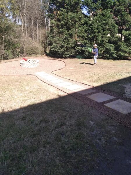 Gravel and Paver stone walkway leading to a fire pit