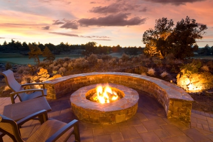 Stone Fire Pit and bench at sunset