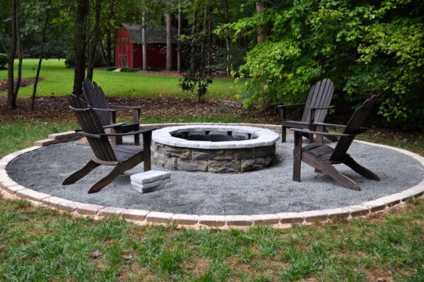 Paver patio with a fire pit and landscaping border