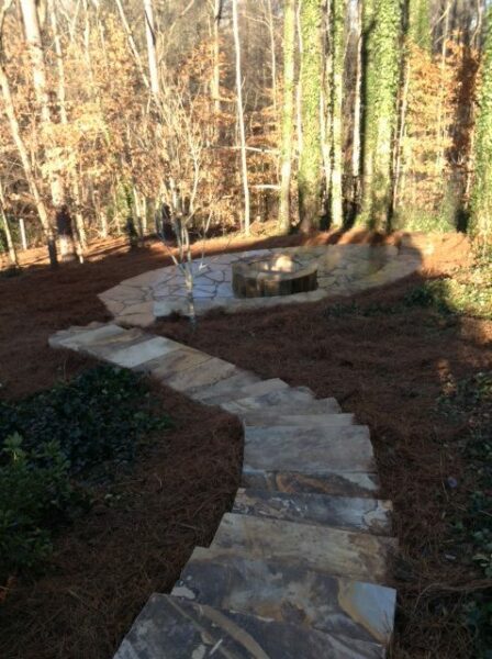 Stone walkway to a patio and fire pit